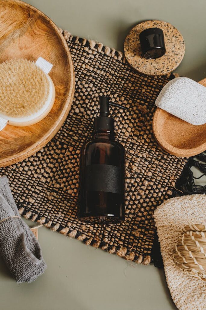 Flat lay of natural skincare products and accessories on woven mat for body care.